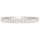 A VERY FINE DIAMOND LINE BRACELET, the oval diamonds mounted in 18ct white gold. Together with 45