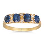 AN ANTIQUE SAPPHIRE FOUR STONE RING, with diamond points, mounted in 18ct carved yellow gold.