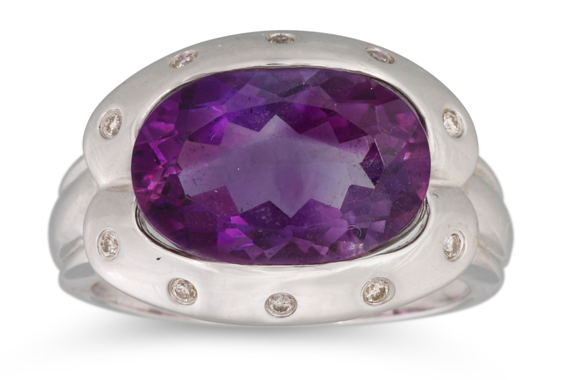 AN AMETHYST AND DIAMOND SET RING, by Tanya Page — Hong Kong, the large oval amethyst surrounded by