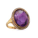 A CABOCHON AMETHYST AND ROSE CUT DIAMOND CLUSTER RING, mounted in 18ct yellow gold. Size: K