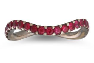 A RUBY ETERNITY RING, of oval wavy design, mounted in 18ct gold, with black rhodium plating, size