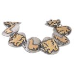 A PERUVIAN BRACELET, silver with 18ct plated overlay of animal motifs