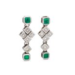 A PAIR OF DIAMOND AND COLOMBIAN EMERALD DROP EARRINGS, the trap cut emeralds to diamond and