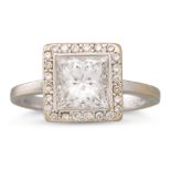 A DIAMOND SOLITAIRE RING, the princess cut diamond to diamond surround, mounted in white gold.