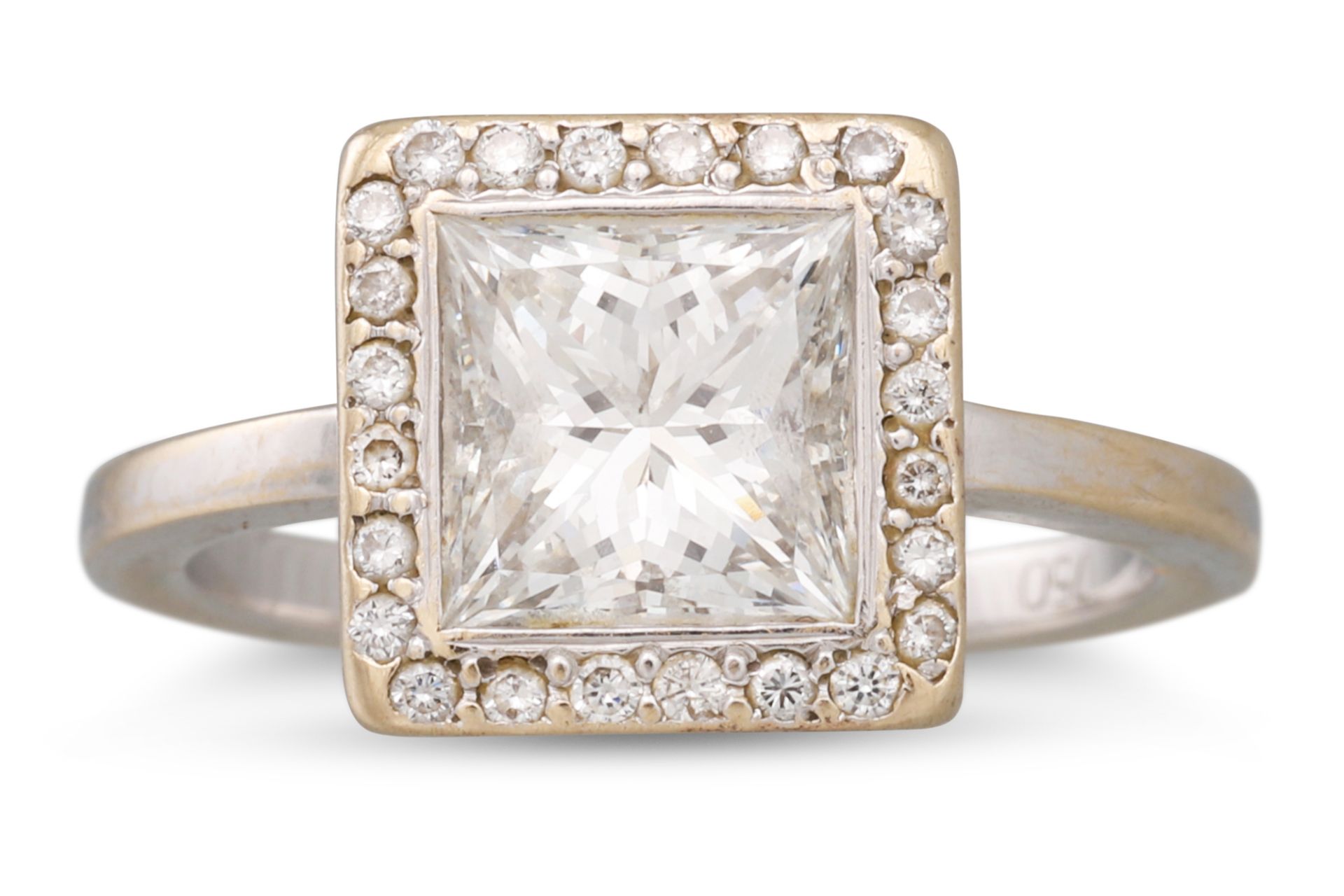 A DIAMOND SOLITAIRE RING, the princess cut diamond to diamond surround, mounted in white gold.