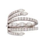 A SIX ROWED DIAMOND RING, cross-over style, set with pear shaped and brilliant cut diamonds, mounted