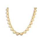 A MAUBOUSSIN NECKLACE, in 18ct yellow gold, each link formed as a heart shaped panel, signed