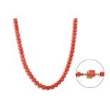 A VINTAGE BEADED CORAL NECKLACE, to a coral set 18ct gold clasp
