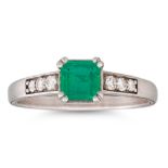 A COLOMBIAN EMERALD AND DIAMOND SET RING, the trap cut emerald to diamond shoulders, mounted in