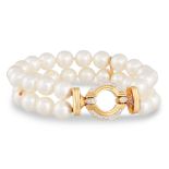 A TWO ROWED CULTURED PEARL BRACELET, with circular 18ct yellow gold and diamond set clasp