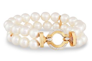 A TWO ROWED CULTURED PEARL BRACELET, with circular 18ct yellow gold and diamond set clasp