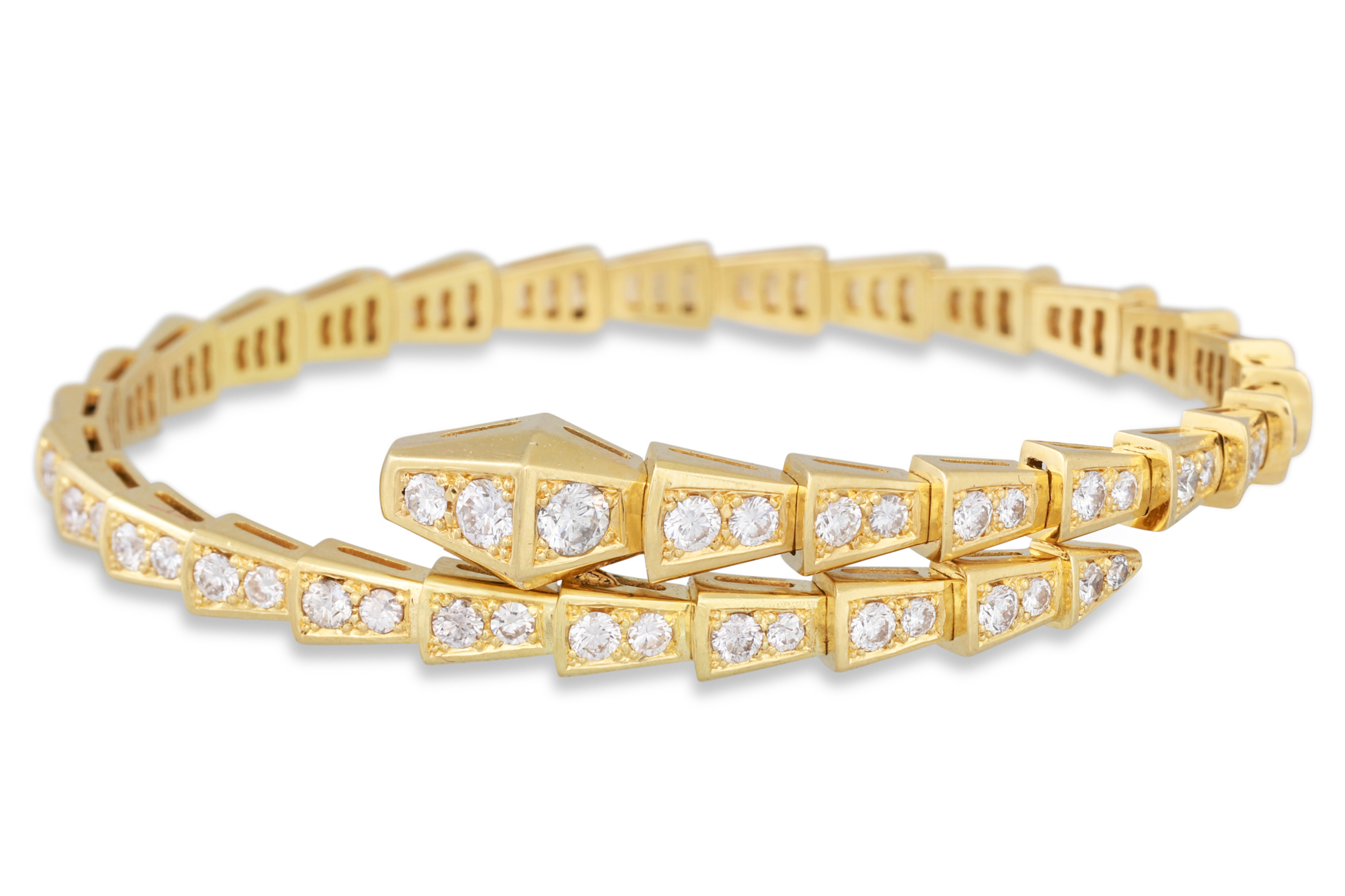 A DIAMOND SET BANGLE, modelled as a snake, cross over style, mounted in yellow gold. Estimated: