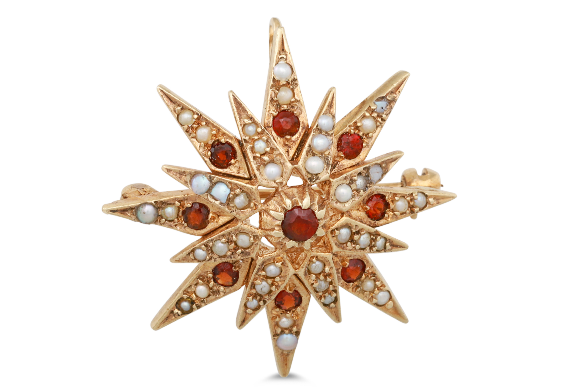 A GARNET AND SEED PEARL BROOCH, in the form of a star, mounted in 9ct gold