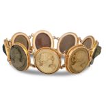 AN ANTIQUE LAVA CAMEO BRACELET, comprising carved cameos depicting ladies in profile, mounted in