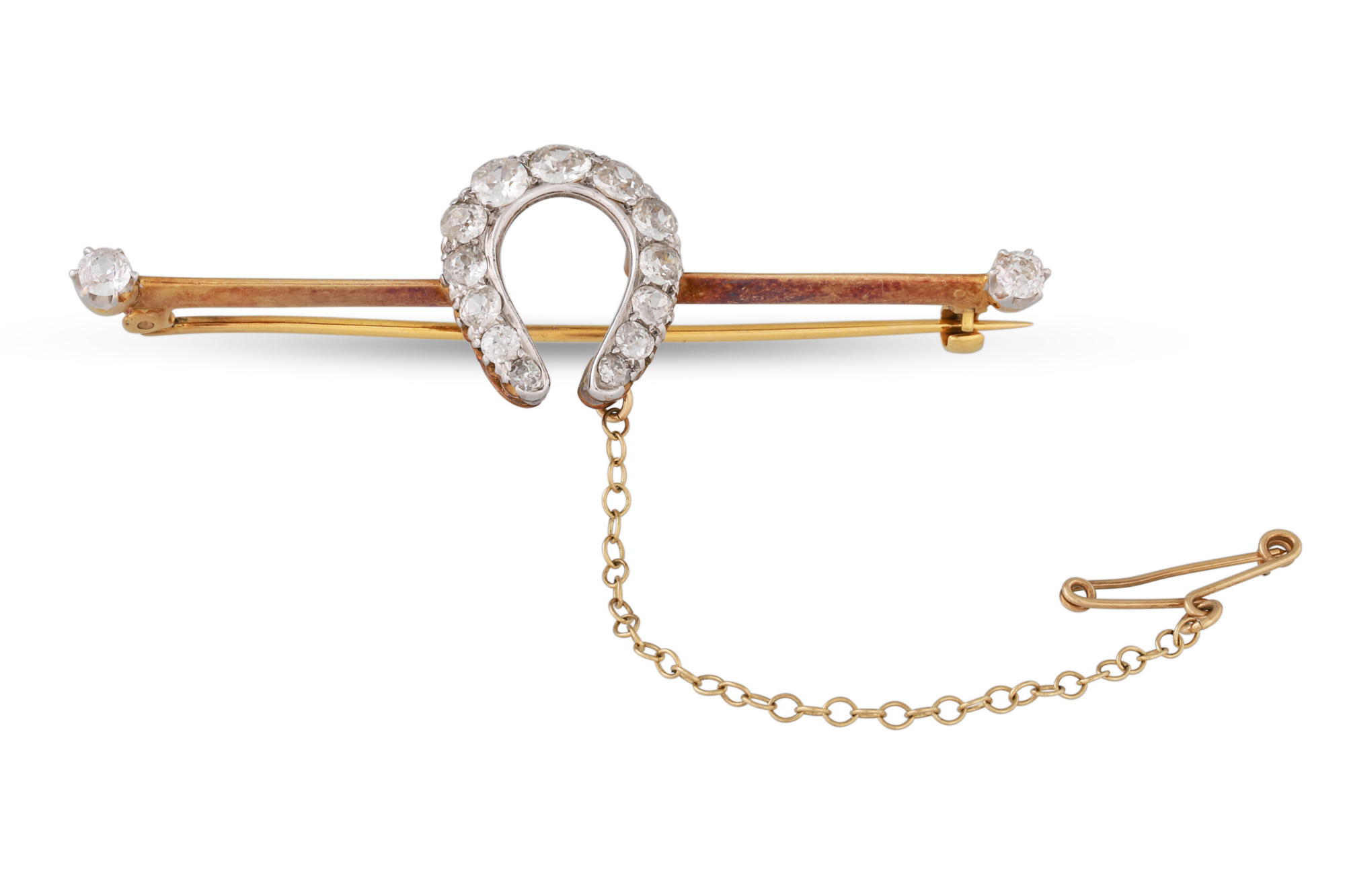 A VICTORIAN DIAMOND SET BROOCH, set with old cut diamonds in horseshoe motif, to a gold knife-edge