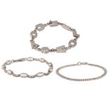 A COLLECTION OF SILVER BRACELETS, one with oval beads and chain link, one curb link and one plain