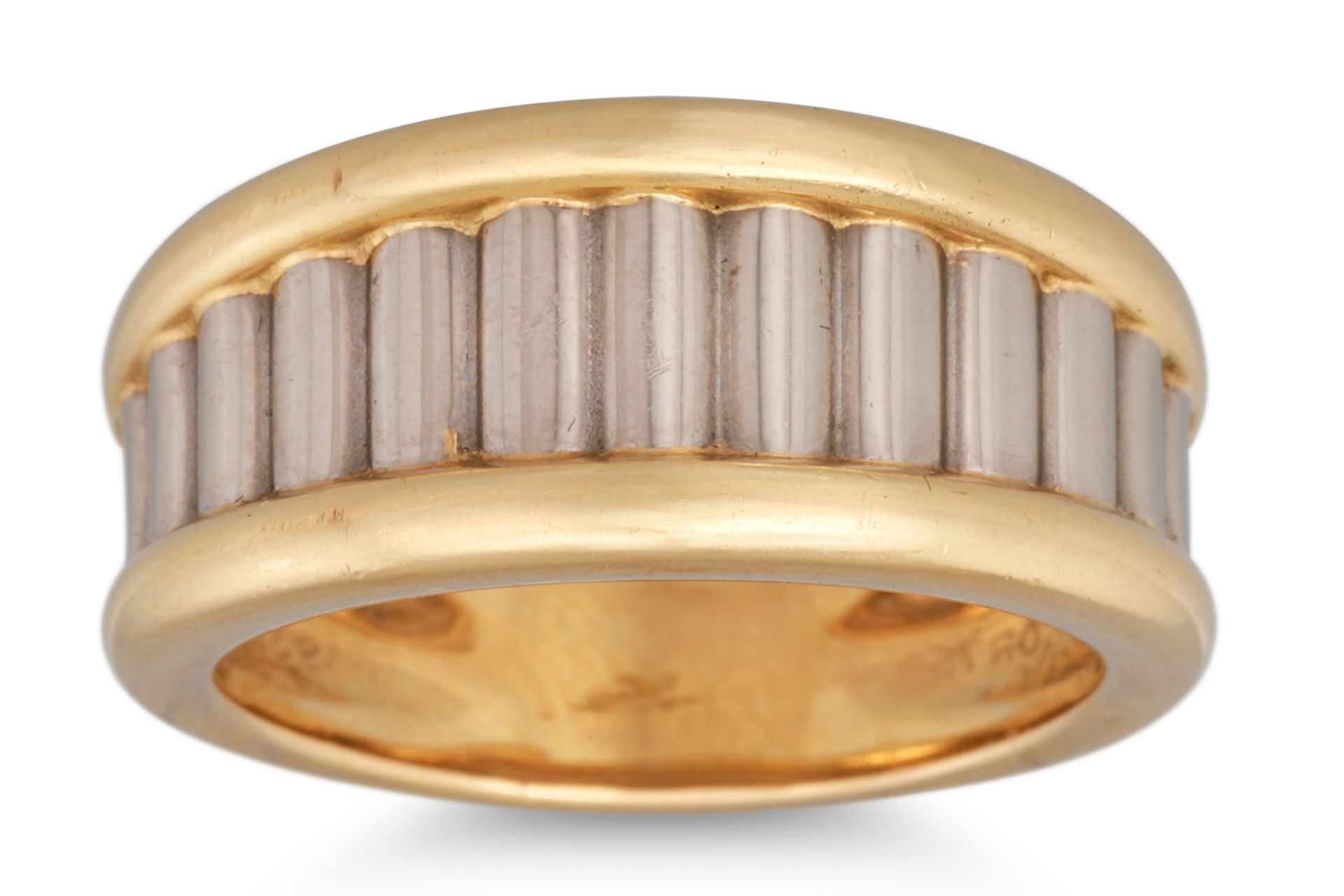 A CARTIER TWO COLOUR GOLD RING, ribbed design, signed Cartier, stamped 750 or, serial # 930541. size