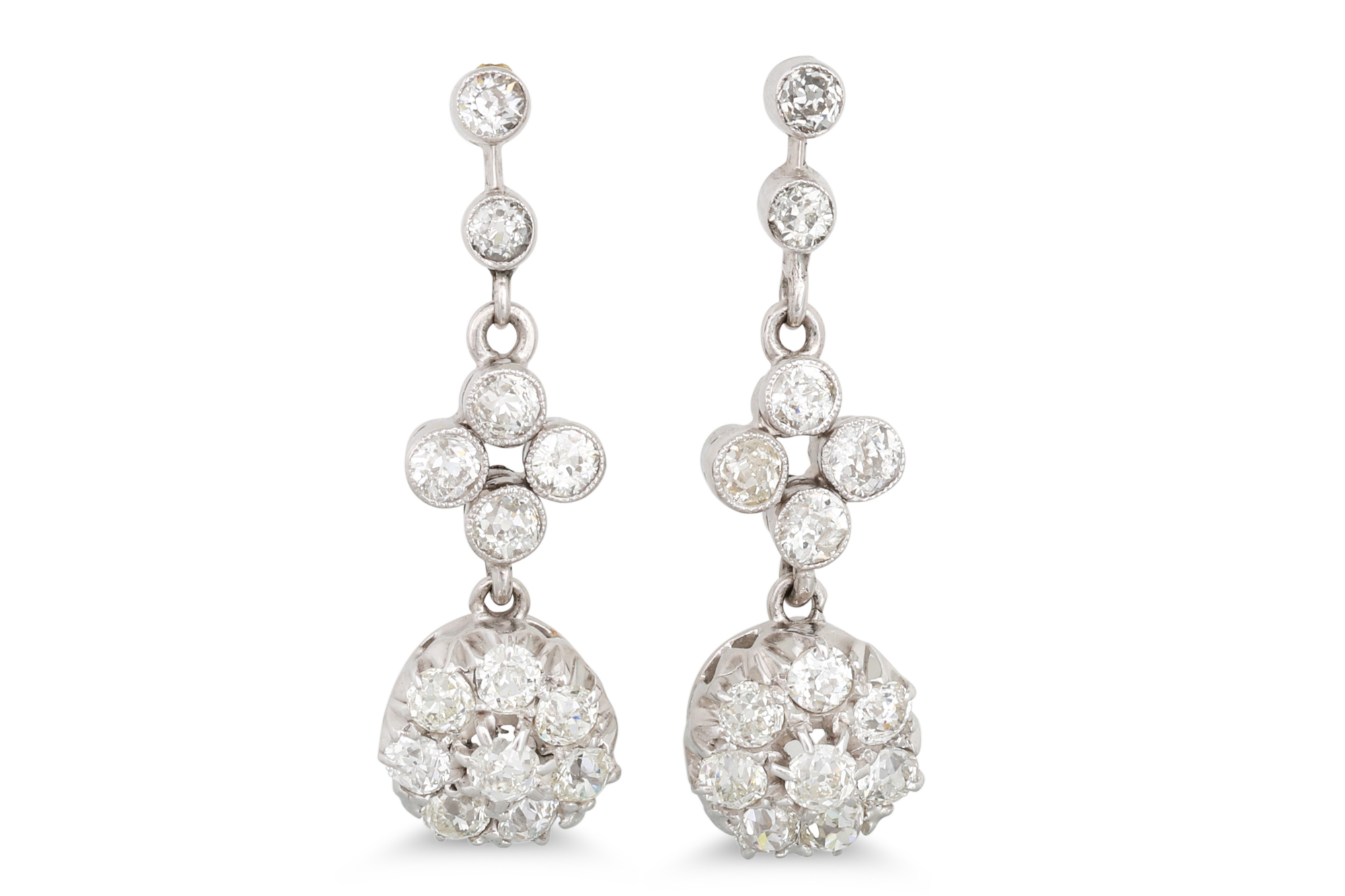 A PAIR OF DIAMOND DROP CLUSTER EARRINGS, the old cut diamonds mounted in white gold. Estimated: