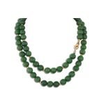 A JADE BEADED NECKLACE, to an 18ct gold clasp