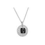 A CHANEL DIAMOND AND BLACK CERAMIC CIRCULAR PENDANT, pavé set with diamonds, French assay mark for