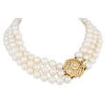 A THREE ROWED CULTURED PEARL NECKLACE, with a circular diamond set 18ct gold clasp