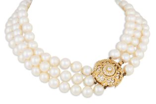 A THREE ROWED CULTURED PEARL NECKLACE, with a circular diamond set 18ct gold clasp