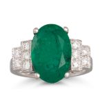 AN EMERALD AND DIAMOND RING, the oval emerald to stepped diamond shoulders, in 18ct white gold.