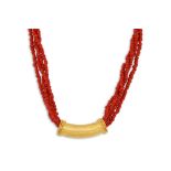 A CORAL BEADED MULTI STRANDED NECKLACE, with a 22ct slider pendant