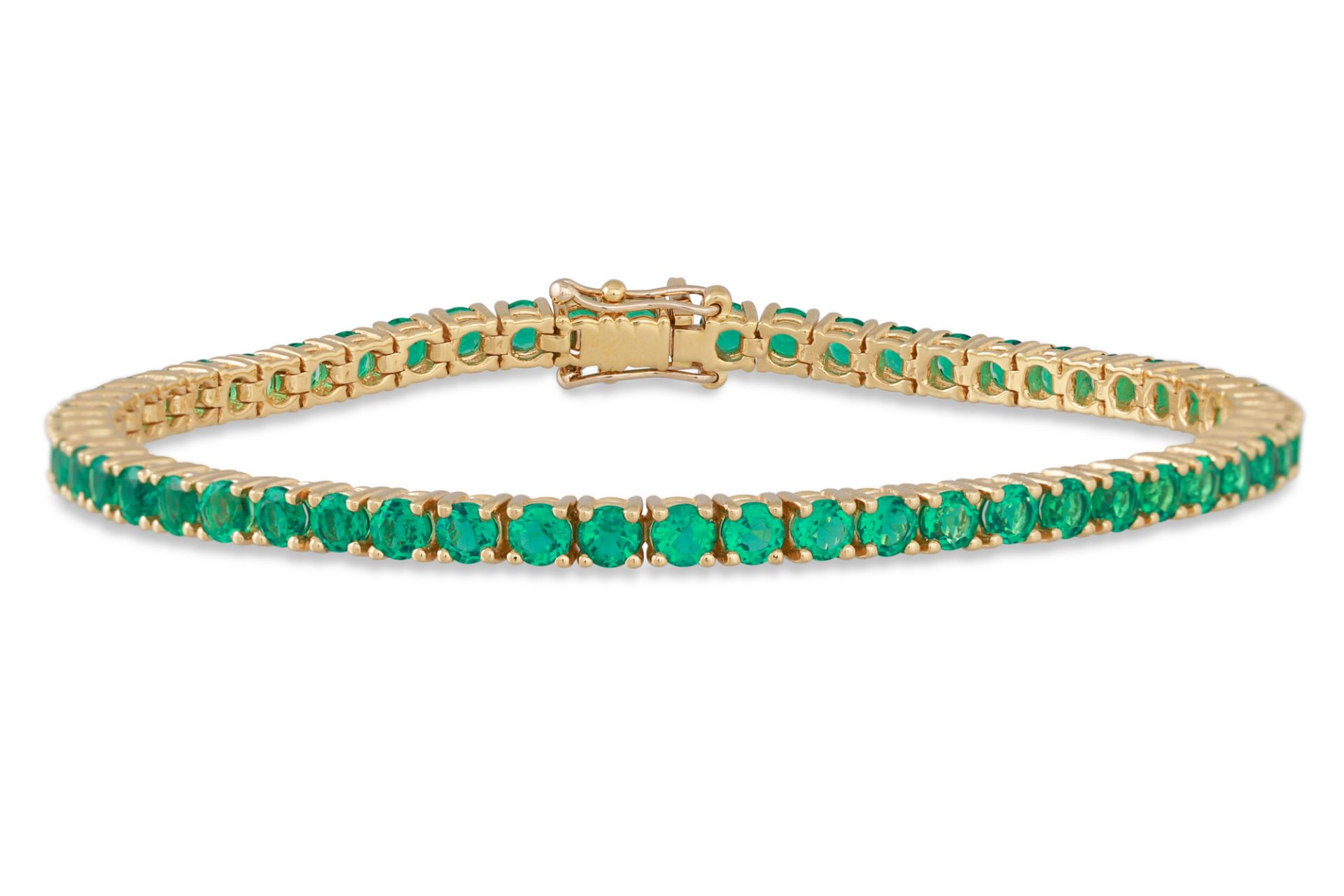 AN EMERALD LINE BRACELET, the circular stones mounted in 18ct gold. Estimated: weight of emeralds: