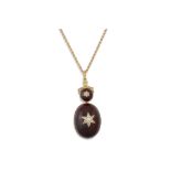 AN ANTIQUE CABOCHON GARNET AND OLD CUT DIAMOND PENDANT, on a gold chain