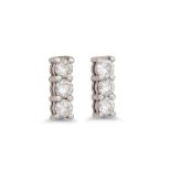 A PAIR OF THREE STONE DIAMOND EARRINGS, in white gold. Estimated: weight of diamonds: 0.60 ct.