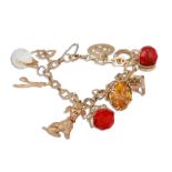 A 9CT YELLOW GOLD CHARM BRACELET, set with various charms, total weight 39.3 g.