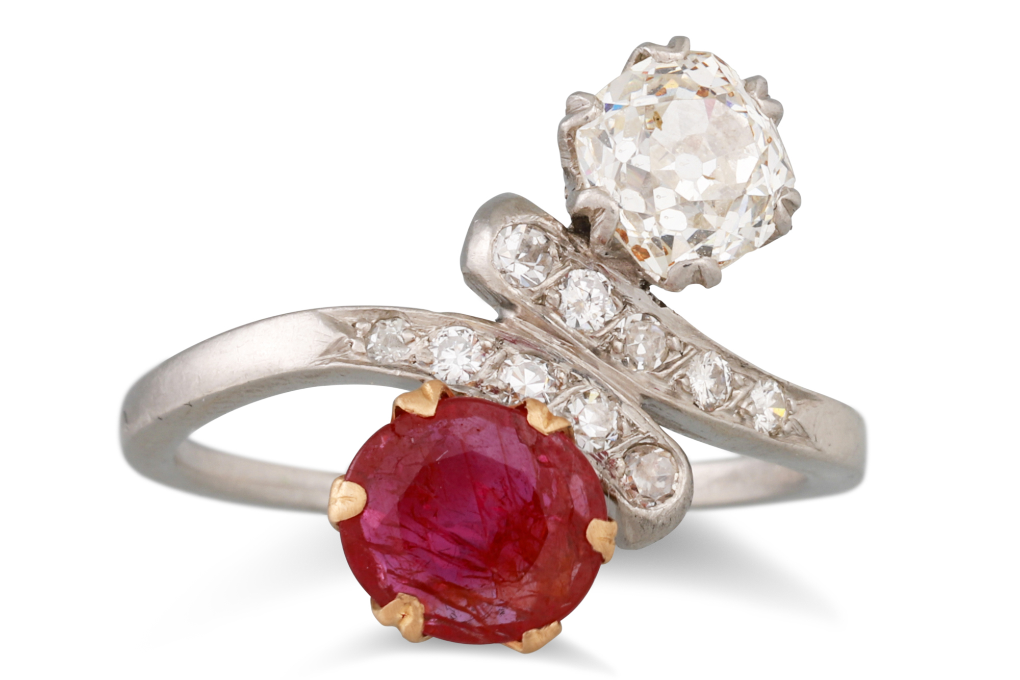 AN ANTIQUE RUBY AND DIAMOND TOI ET MOI RING, set with an old cut diamond and a circular ruby,
