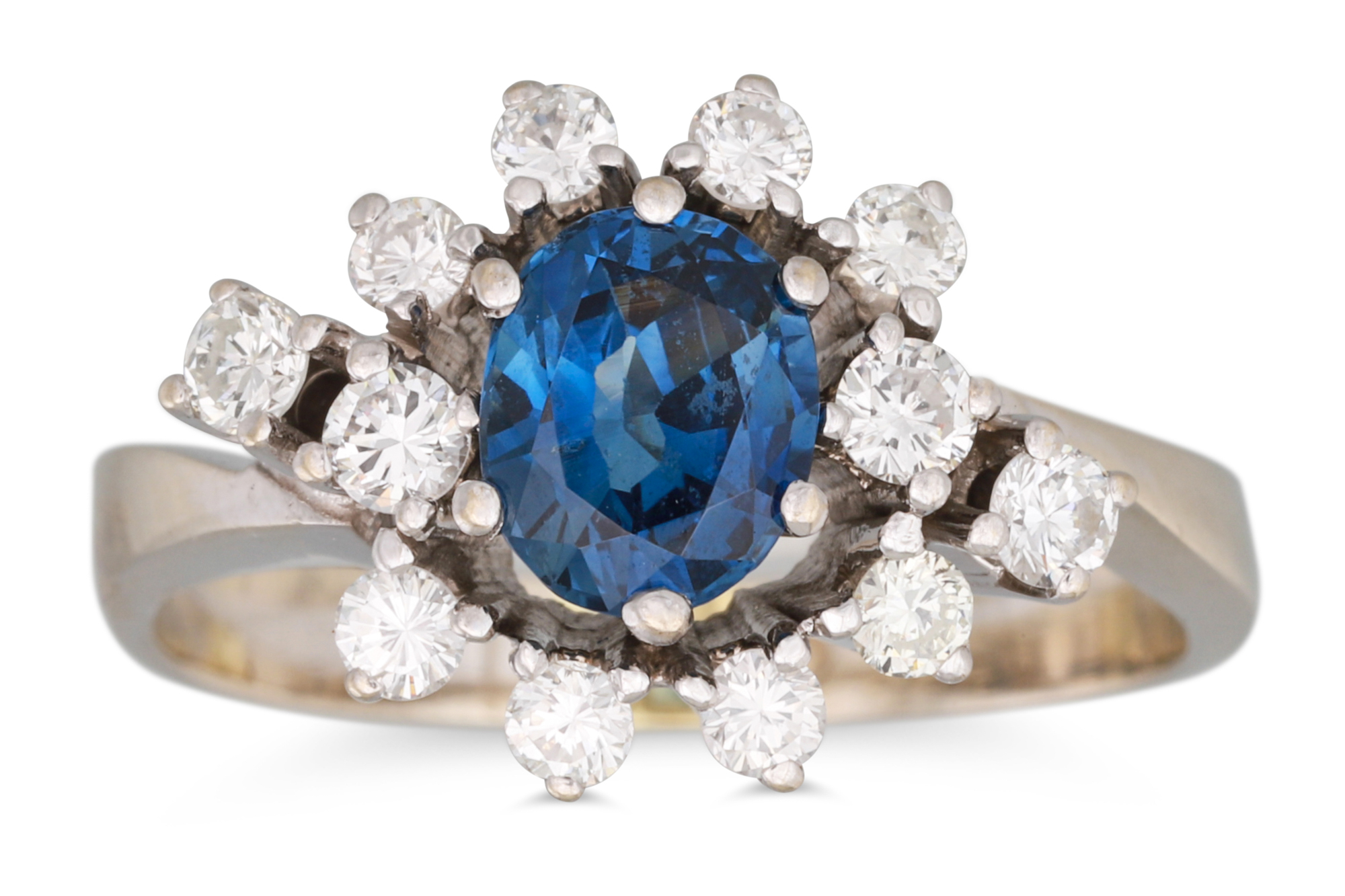 A SAPPHIRE AND DIAMOND CLUSTER RING, the oval sapphire to diamond surround, mounted in 14ct white