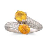 A YELLOW SAPPHIRE AND DIAMOND CROSS-OVER RING, mounted in white gold. Estimated: weight of