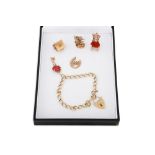 A 9CT GOLD CHARM BRACELET, various charms, 33 g.
