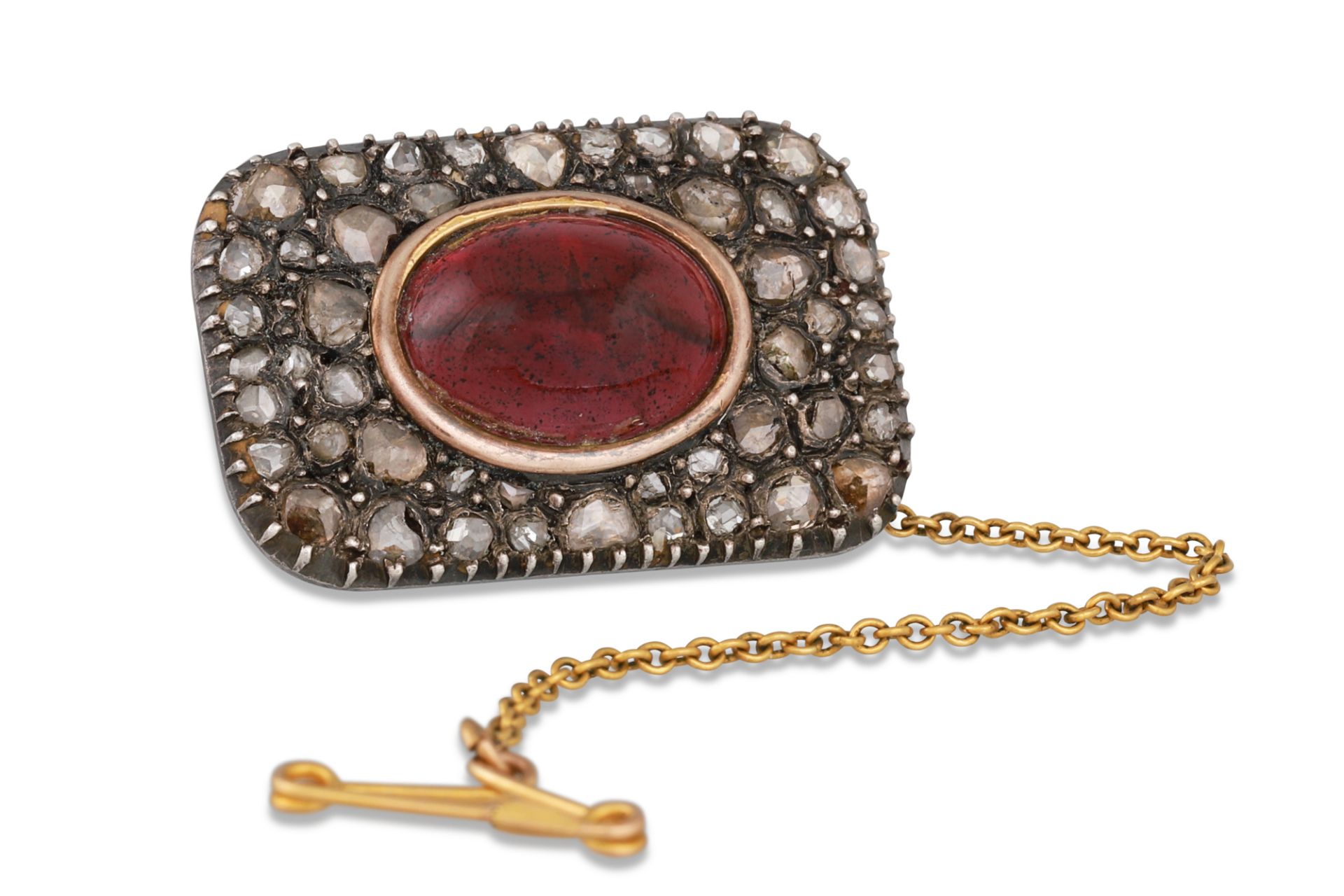 AN ANTIQUE CABOCHON GARNET AND ROSE CUT DIAMOND BROOCH, safety chain • Approx. 1.1" x 0.80"