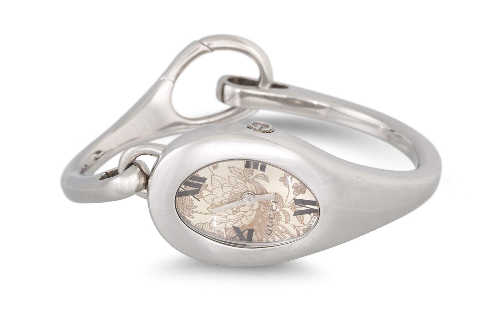 A LADY'S STAINLESS STEEL HORSE BIT WATCH, champagne floral face with Roman numerals, papers