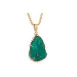 AN EMERALD CRYSTAL PENDANT, to a 18ct gold mount, on a chain (not gold) ** purchased by vendor in