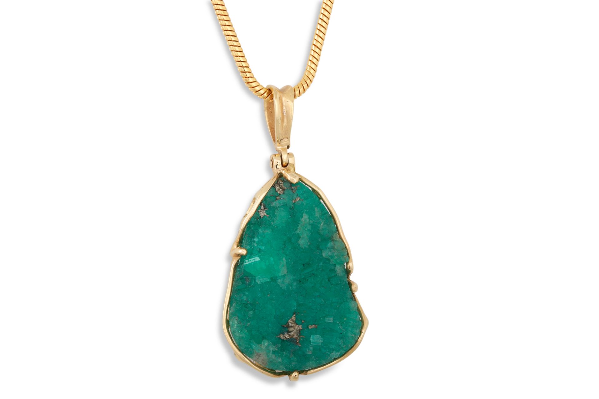 AN EMERALD CRYSTAL PENDANT, to a 18ct gold mount, on a chain (not gold) ** purchased by vendor in