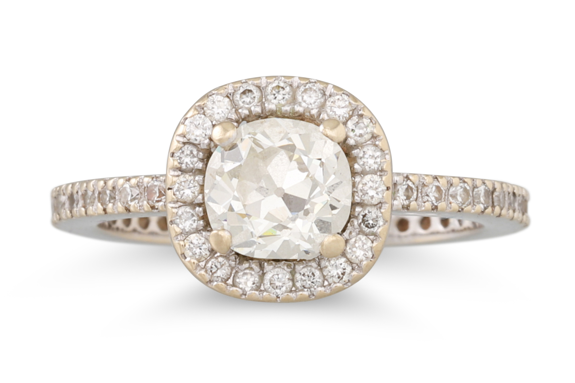 A DIAMOND SOLITAIRE RING, the old cut diamond to a diamond halo surround and shoulders, mounted in