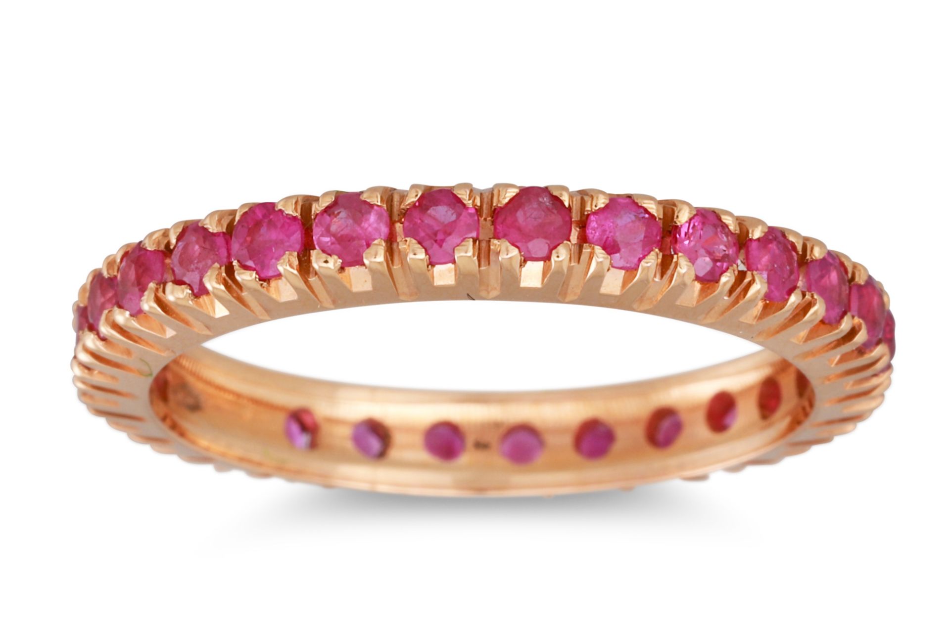 A RUBY ETERNITY RING, the circular stones mounted in 18ct yellow gold. Estimated: weight of