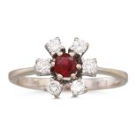 A RUBY AND DIAMOND CLUSTER RING, the circular ruby to diamond surround, mounted in 14ct white