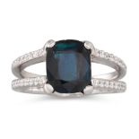 A DEEP BLUE SAPPHIRE AND DIAMOND RING, the cushion cut sapphire to a split diamond shoulders,
