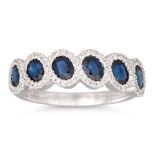 A DIAMOND AND SAPPHIRE CLUSTER RING, mounted in 18ct gold, size N - O