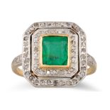 AN EMERALD AND DIAMOND CLUSTER RING, the rectangular emerald to a two rowed old cut diamond