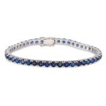 A SAPPHIRE LINE BRACELET, the circular stones mounted in 18ct yellow gold. Estimated: weight of
