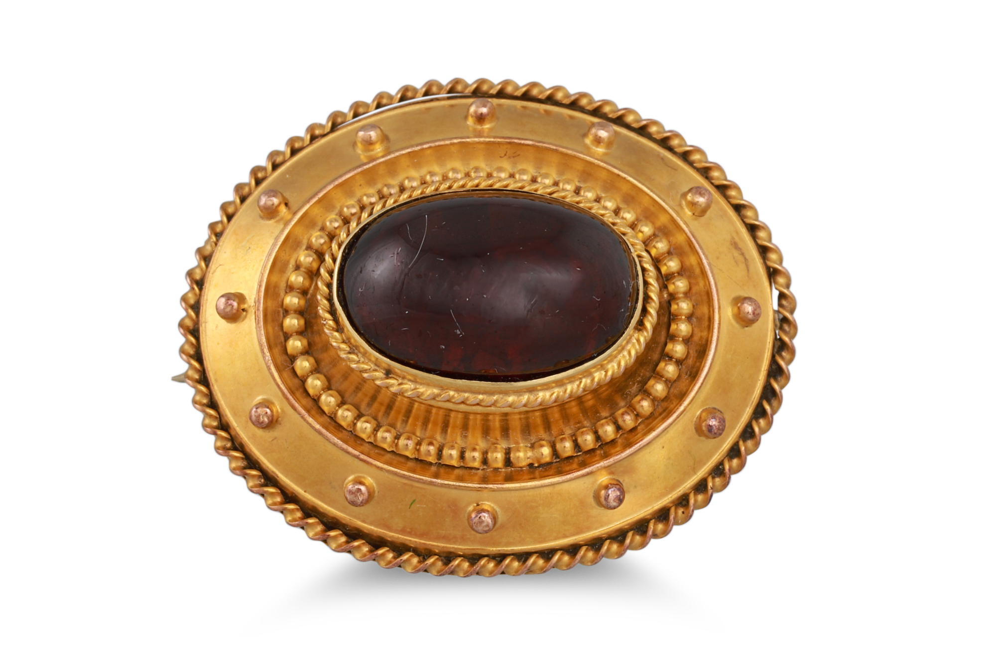 AN ANTIQUE GOLD PLATED BROOCH, Etruscan style, set with a cabochon garnet