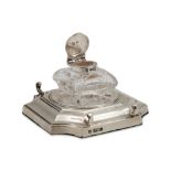 AN EDWARDIAN SILVER DETACHABLE INK WELL, square form, cut glass with carved corners, silver top,