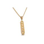 AN EGYPTIAN GOLD PENDANT, on a 22ct gold chain